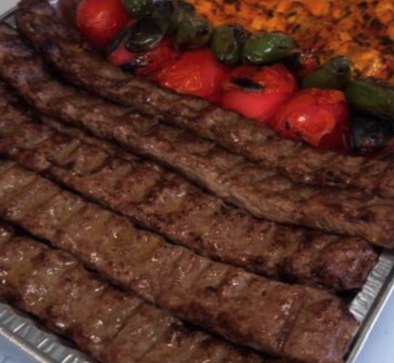 Beef kebab over rice and salad
