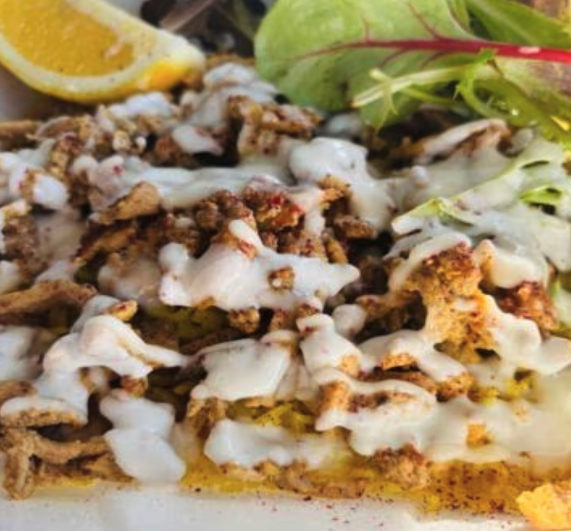 Chicken shawarma , over rice with garlic sauce